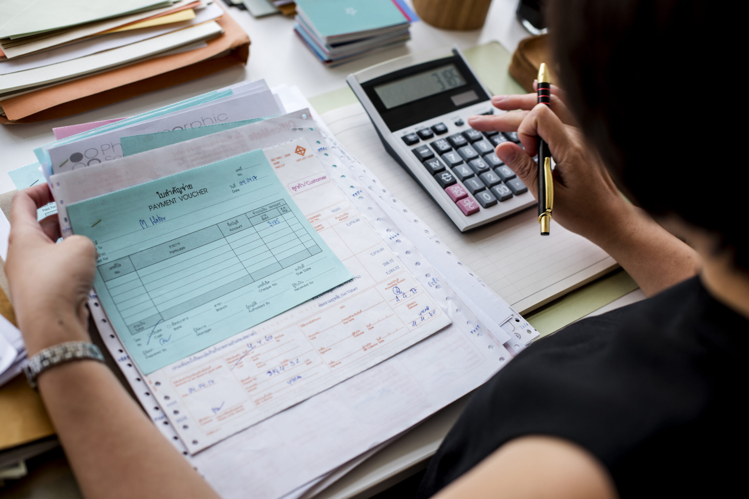 asian-woman-working-through-paperwork Home