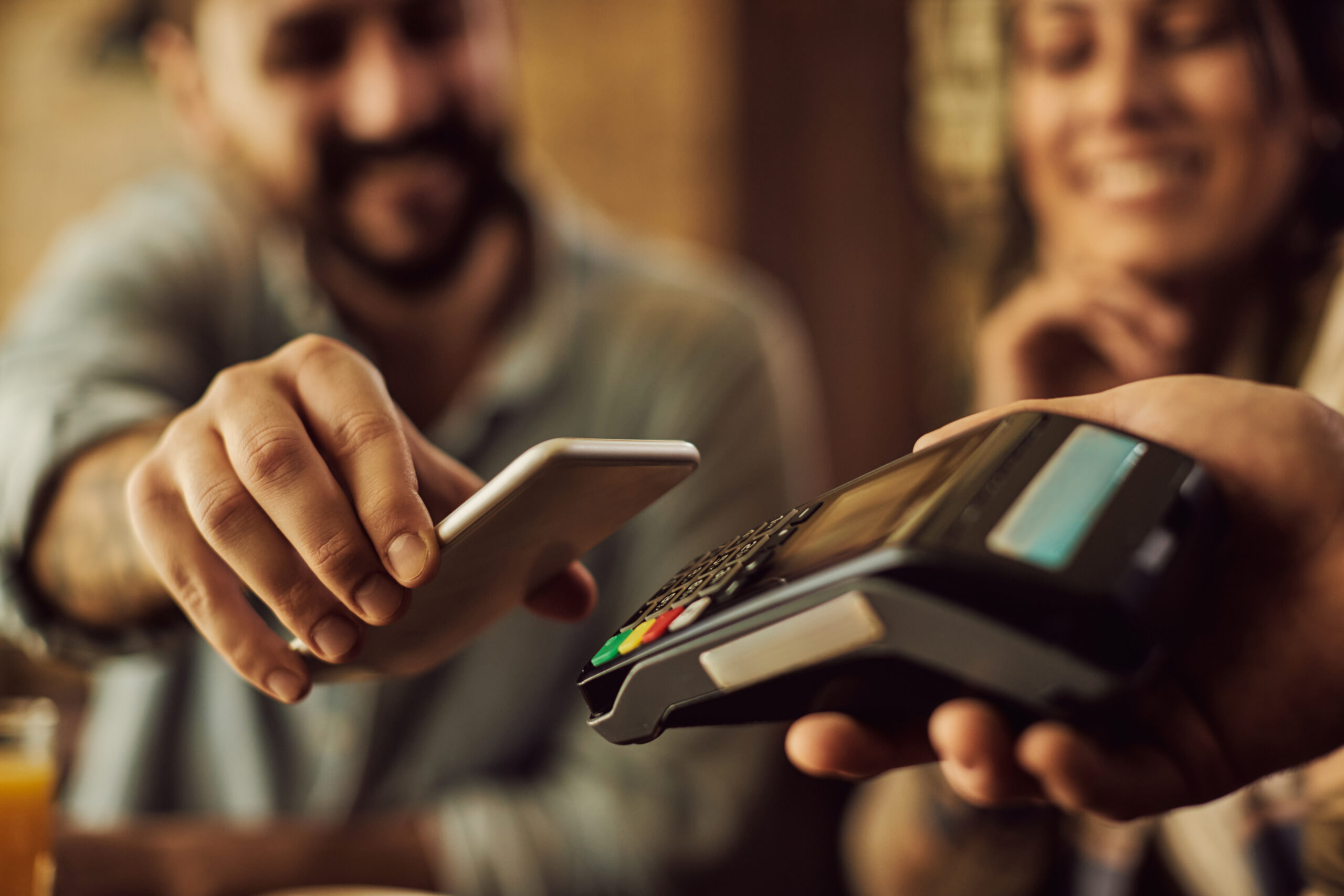 closeup-man-making-contactless-payment-with-smart-phone Home